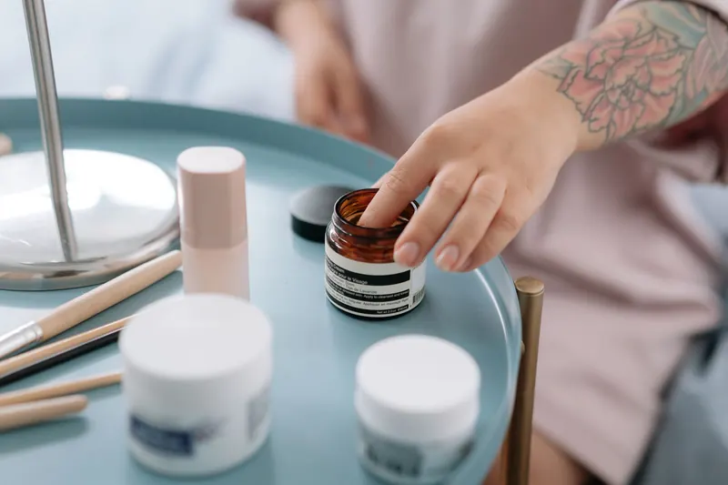 Assorted skincare cream jars arranged on a marble surface, showcasing beauty and elegance