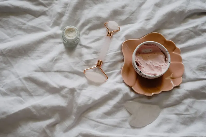 A flat lay of skincare tools and products for a rejuvenating beauty routine